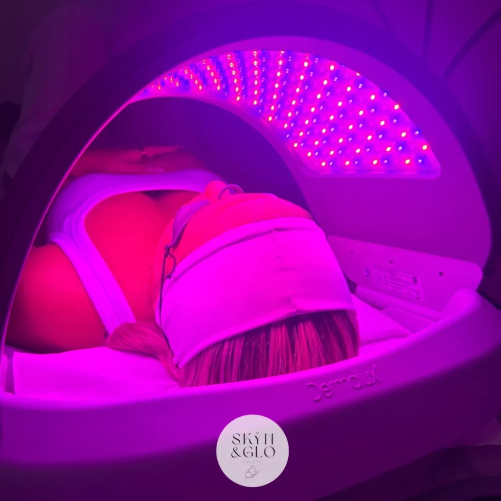 A woman receiving Dermaplane & Peel LED light therapy treatment